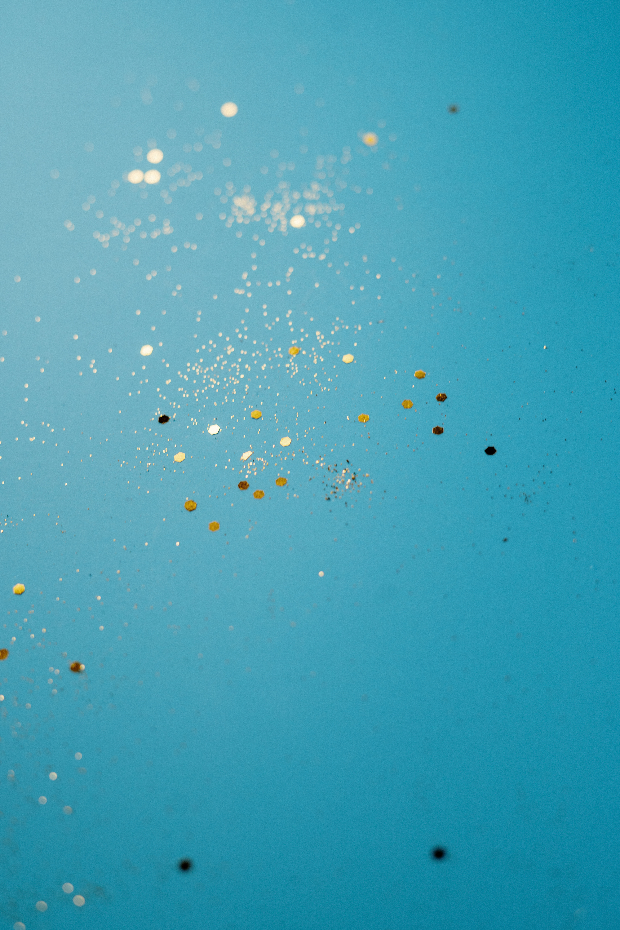 Glitters on Blue Surface
